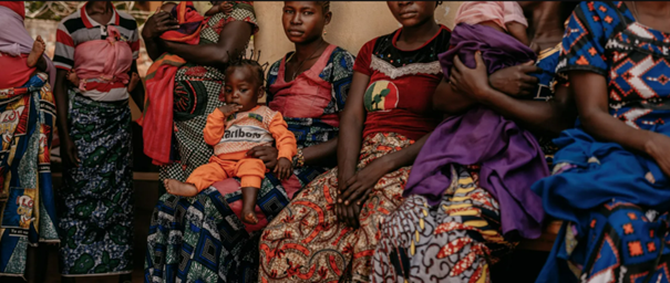 A group of women in colourful clothing, with their children, at an ICRC-supported health centre in Doukouma, Central African Republic.