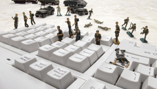 Toy soldiers spreading on a keyboard.