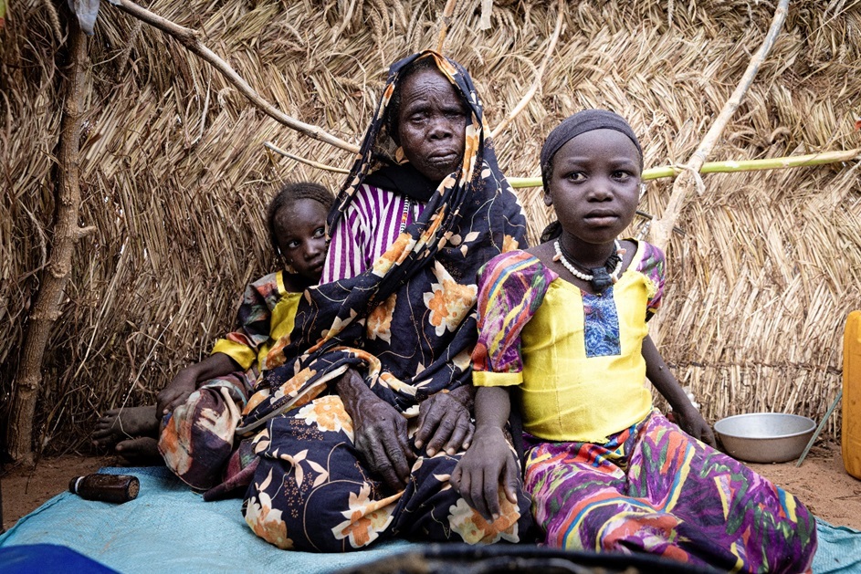Woman with two children struggling with hunger in Chad, Sudan.