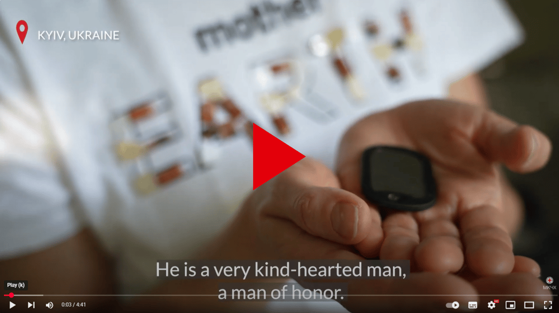 Video vignette showing a close up on hands holding military identification plates.